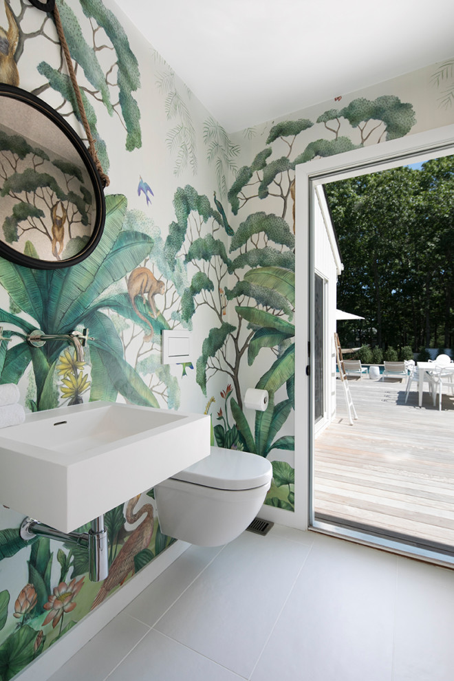 Immagine di un bagno di servizio stile marino con pareti multicolore, lavabo sospeso, pavimento grigio e carta da parati