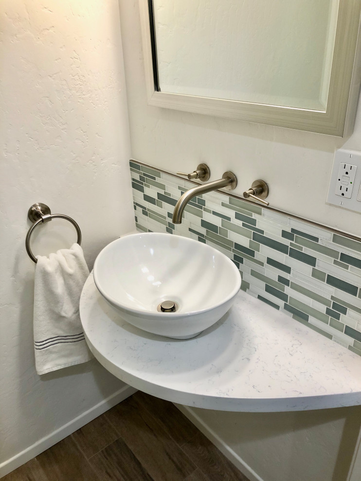 Example of a small minimalist multicolored tile and glass tile porcelain tile and brown floor powder room design in Santa Barbara with white walls, a vessel sink, quartz countertops, white countertops and a floating vanity