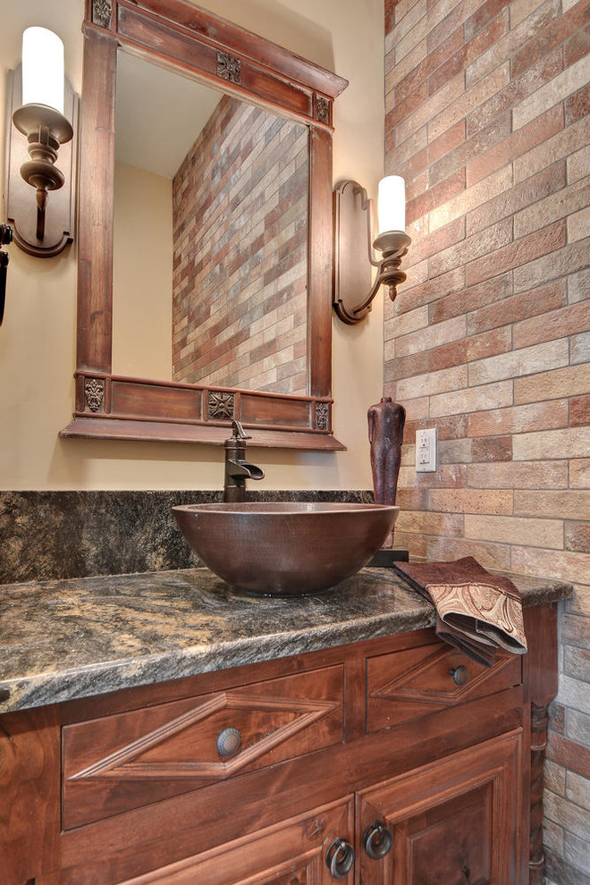 Example of a small classic beige tile porcelain tile powder room design in Austin with furniture-like cabinets, medium tone wood cabinets, a one-piece toilet, beige walls, a vessel sink and granite countertops