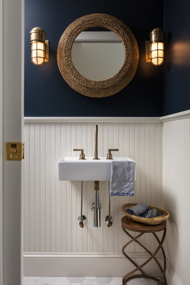 Inspiration for a small coastal marble floor and white floor powder room remodel in New York with blue walls and a wall-mount sink