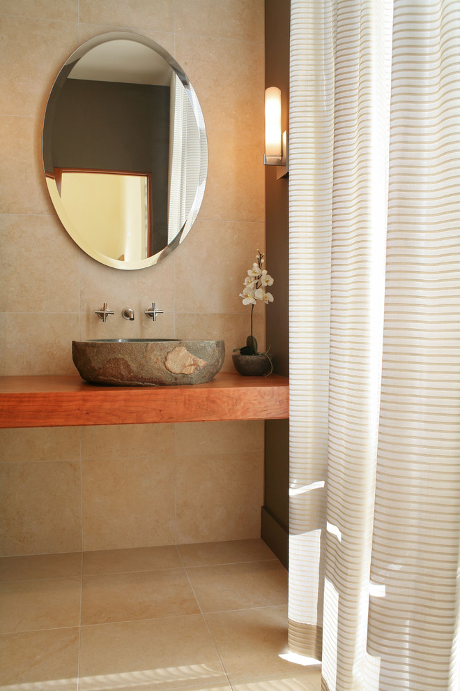 Minimalist powder room photo in Milwaukee with a vessel sink, wood countertops and brown countertops