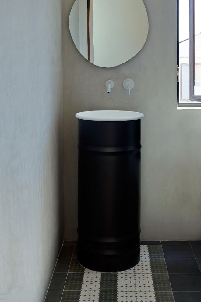 Inspiration for a medium sized contemporary cloakroom in Los Angeles with beige walls, ceramic flooring, a pedestal sink, multi-coloured floors, freestanding cabinets and black cabinets.