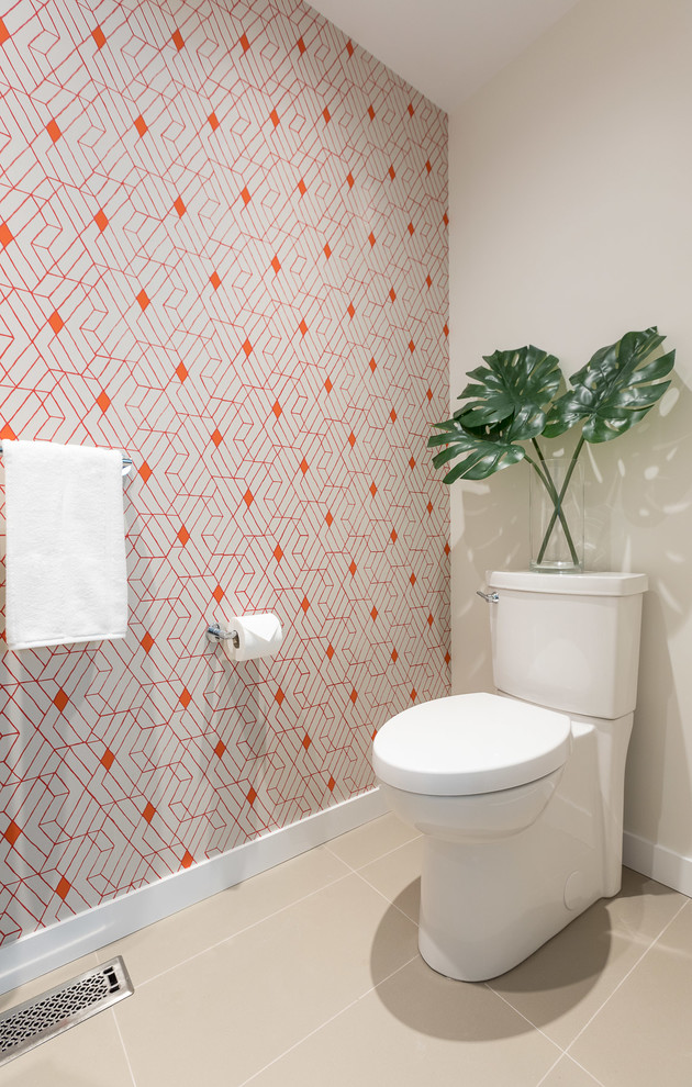 Inspiration for a small contemporary cloakroom in Vancouver with flat-panel cabinets, beige cabinets, a two-piece toilet, beige tiles, stone slabs, multi-coloured walls, porcelain flooring, an integrated sink, solid surface worktops, beige floors and white worktops.