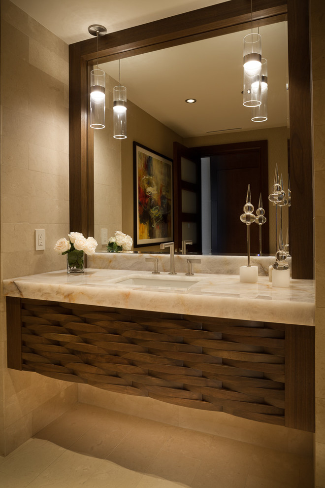 Example of a mid-sized trendy beige tile and limestone tile limestone floor and beige floor powder room design in Miami with brown cabinets, beige walls, an undermount sink and quartzite countertops
