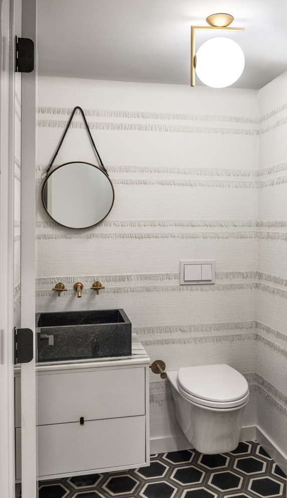 Design ideas for a contemporary cloakroom in Chicago with a vessel sink, flat-panel cabinets, white cabinets, a wall mounted toilet and white walls.