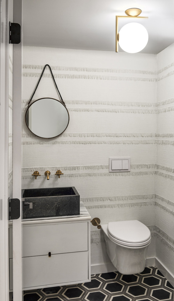 Trendy powder room photo in Chicago with a vessel sink, flat-panel cabinets, white cabinets, a wall-mount toilet and white walls