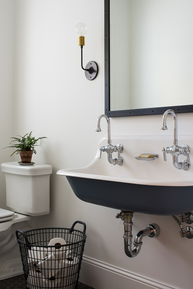 This is an example of a rural cloakroom in Minneapolis with a two-piece toilet, white walls, mosaic tile flooring and a wall-mounted sink.