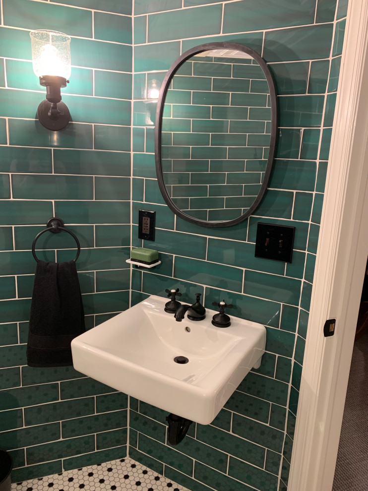 Photo of a small industrial cloakroom in New York with a one-piece toilet, green tiles, ceramic tiles, ceramic flooring, a wall-mounted sink, white floors and a floating vanity unit.