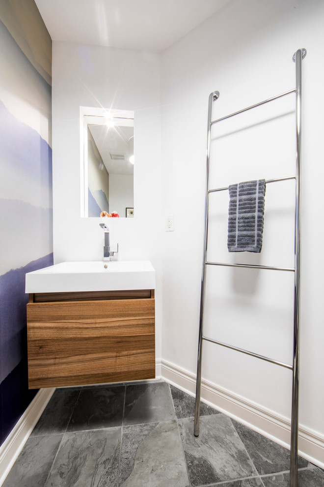 Medium sized modern cloakroom in Toronto with flat-panel cabinets, medium wood cabinets, a one-piece toilet, white walls, slate flooring, an integrated sink, engineered stone worktops, grey floors and white worktops.