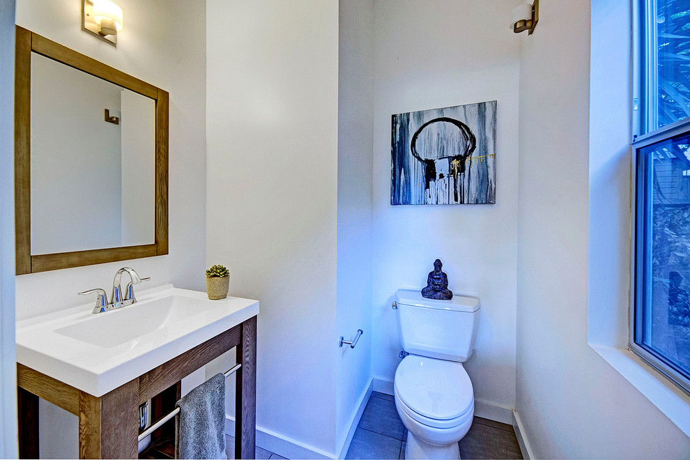 Mid-sized trendy ceramic tile and gray floor powder room photo in Other with open cabinets, medium tone wood cabinets, a two-piece toilet, white walls and a drop-in sink