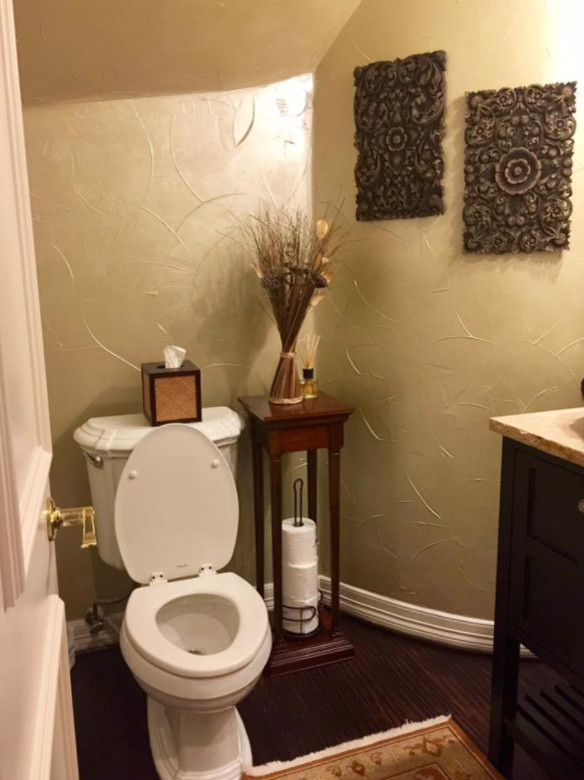 Inspiration for a small mediterranean cloakroom in Dallas with freestanding cabinets, dark wood cabinets, a two-piece toilet, beige walls, dark hardwood flooring, limestone worktops and brown floors.