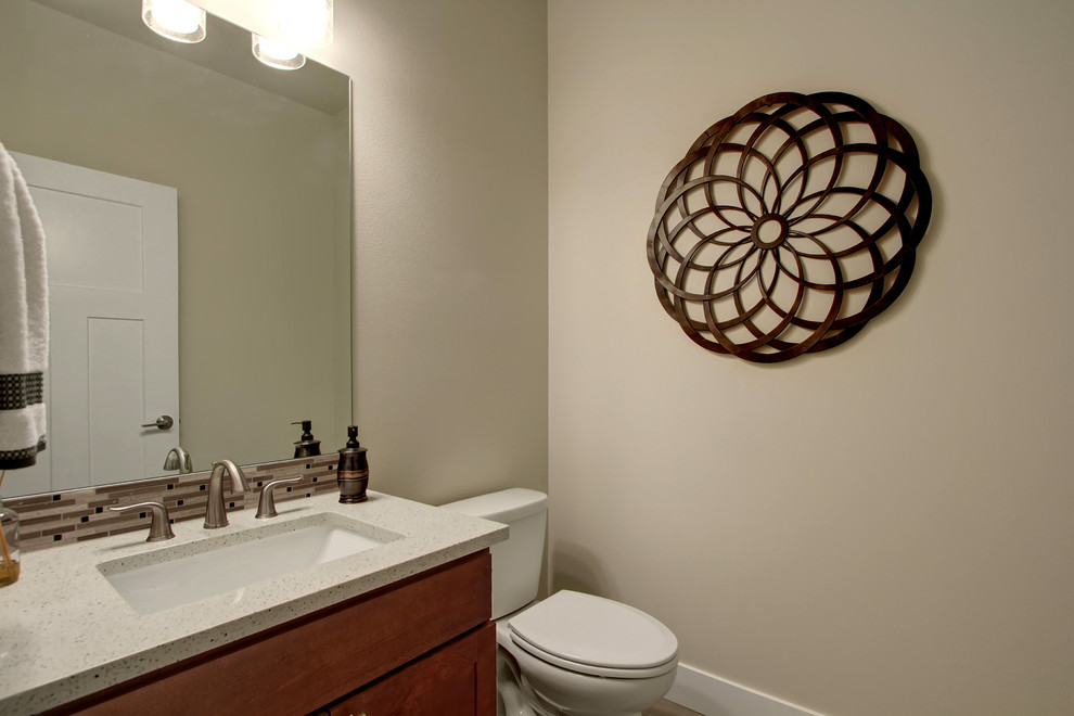 This is an example of a medium sized classic cloakroom in Seattle with shaker cabinets, dark wood cabinets, a two-piece toilet, ceramic tiles, ceramic flooring, a submerged sink and engineered stone worktops.