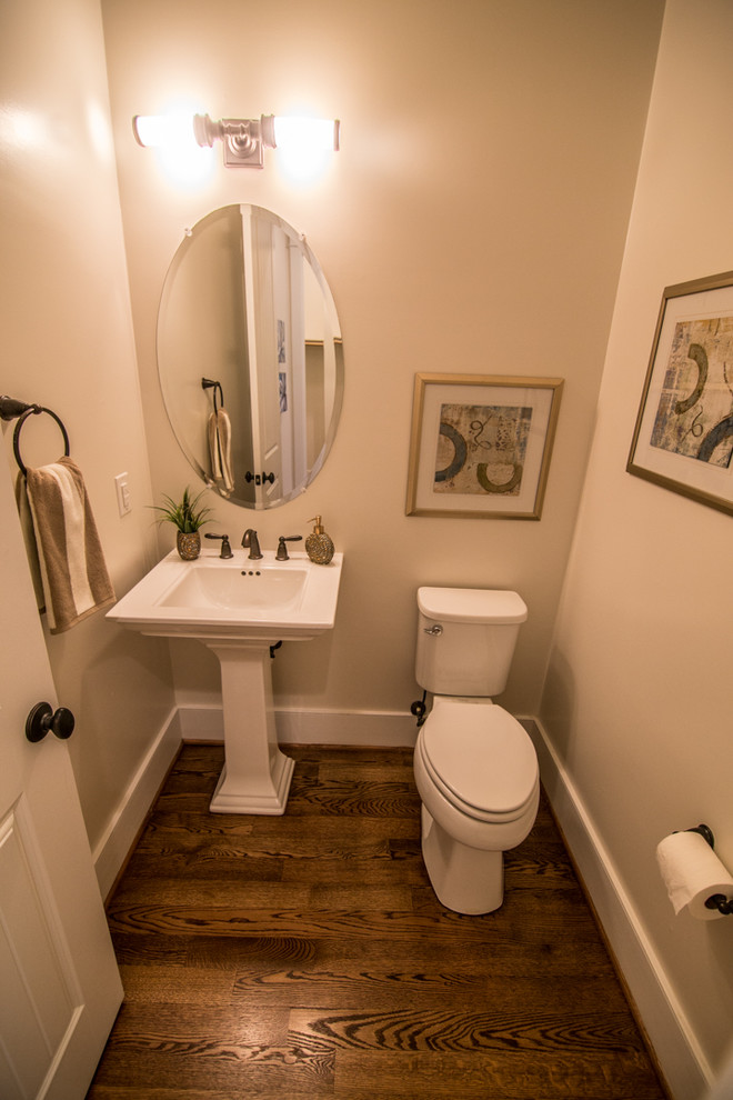 This is an example of a classic cloakroom in DC Metro with a pedestal sink and a two-piece toilet.