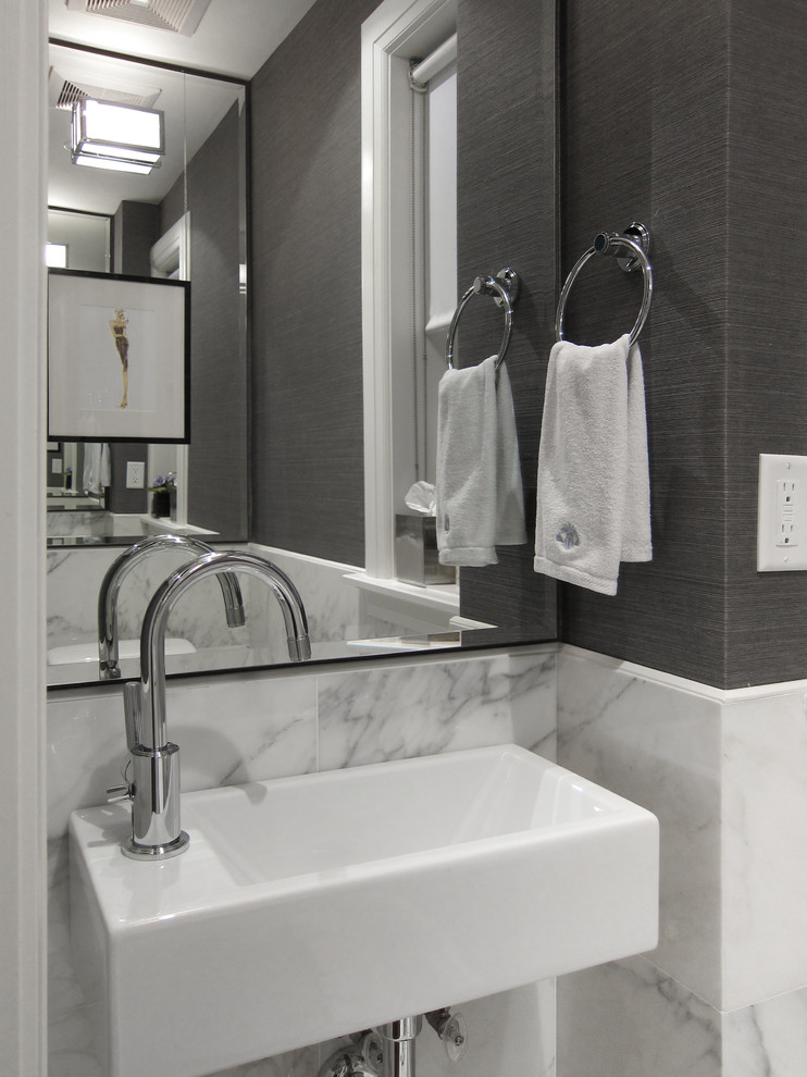 Powder room - small modern marble tile marble floor powder room idea in Toronto with gray walls and a wall-mount sink
