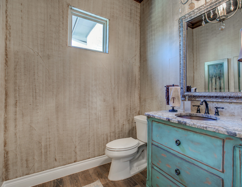 Photo of a medium sized rustic cloakroom in Austin with flat-panel cabinets, blue cabinets, beige walls, medium hardwood flooring, a submerged sink, engineered stone worktops, beige floors and grey worktops.