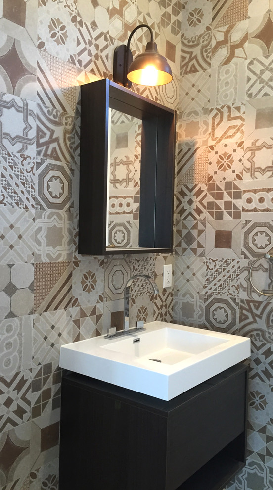 Mid-sized transitional multicolored tile and porcelain tile porcelain tile powder room photo in Los Angeles with flat-panel cabinets, dark wood cabinets, a two-piece toilet, white walls, quartz countertops and an integrated sink