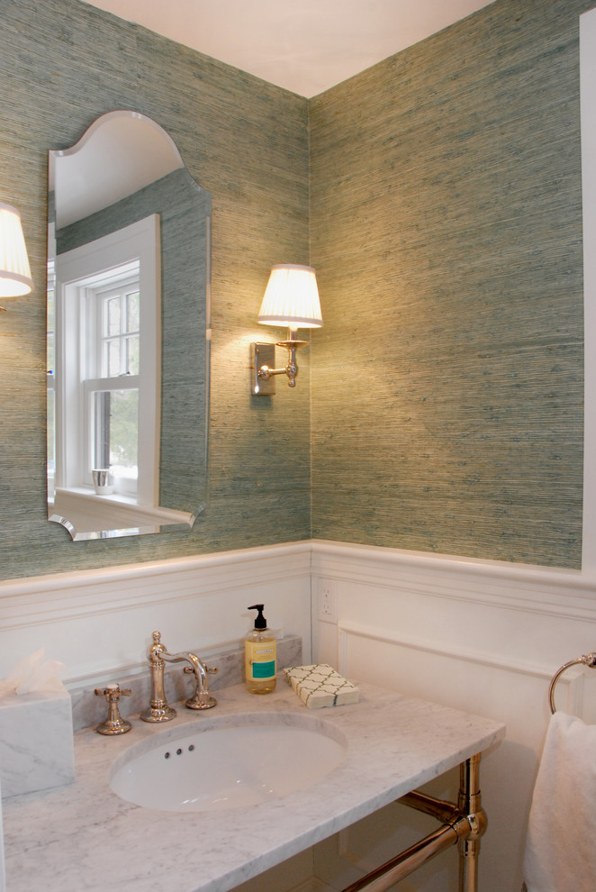 Powder room - small traditional powder room idea in Boston with an undermount sink, marble countertops and green walls