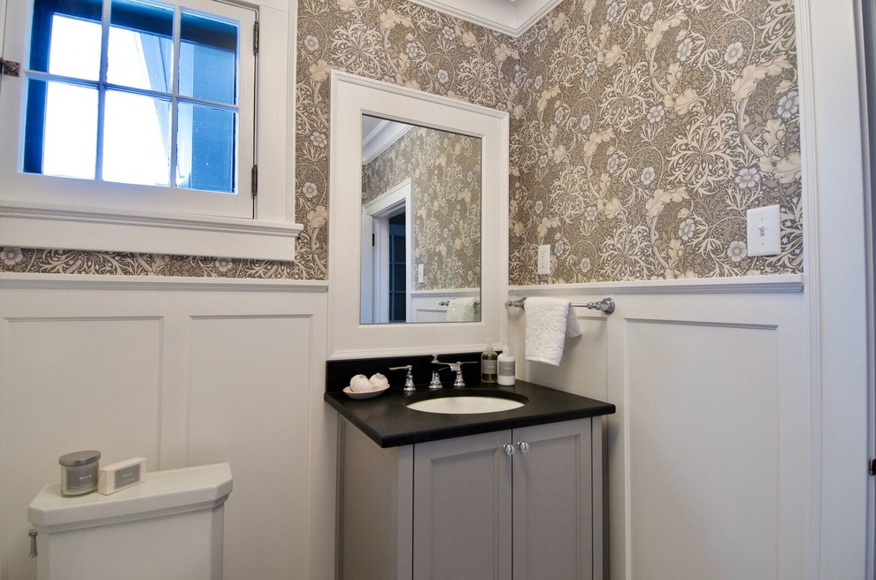 Powder room - small traditional powder room idea in Minneapolis with beaded inset cabinets, gray cabinets, brown walls, an undermount sink, quartz countertops and black countertops