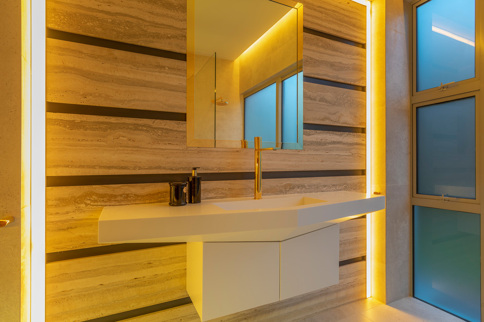Design ideas for a large contemporary cloakroom in Auckland with flat-panel cabinets, white cabinets, multi-coloured tiles, stone slabs, multi-coloured walls, travertine flooring, a wall-mounted sink, solid surface worktops, multi-coloured floors and white worktops.