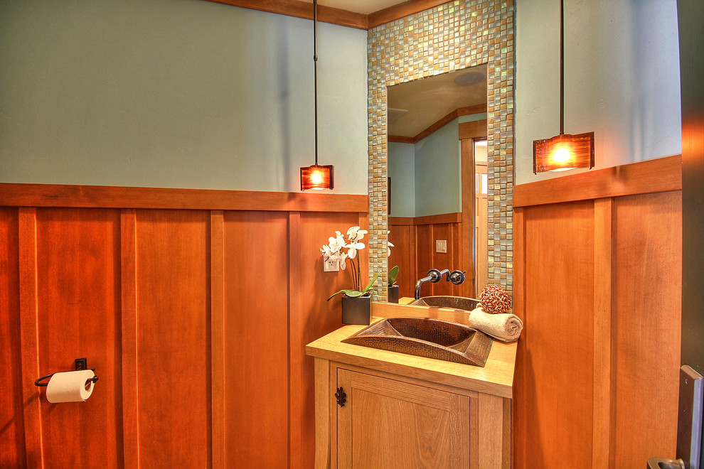 На фото: туалет в стиле кантри с накладной раковиной, фасадами в стиле шейкер, светлыми деревянными фасадами, разноцветной плиткой и плиткой мозаикой с