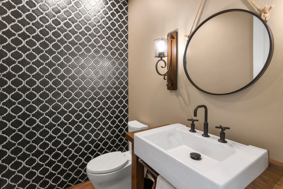 Photo of a medium sized contemporary cloakroom in Other with open cabinets, dark wood cabinets, a two-piece toilet, black tiles, ceramic tiles, beige walls, dark hardwood flooring, a console sink, wooden worktops, brown floors and brown worktops.