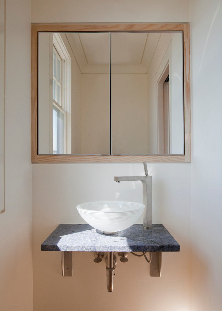 This is an example of a large contemporary cloakroom in Boston with a vessel sink and white walls.