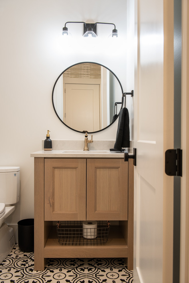 This is an example of a small classic cloakroom in Salt Lake City with recessed-panel cabinets, light wood cabinets, a two-piece toilet, white walls, ceramic flooring, a submerged sink, quartz worktops, multi-coloured floors and white worktops.