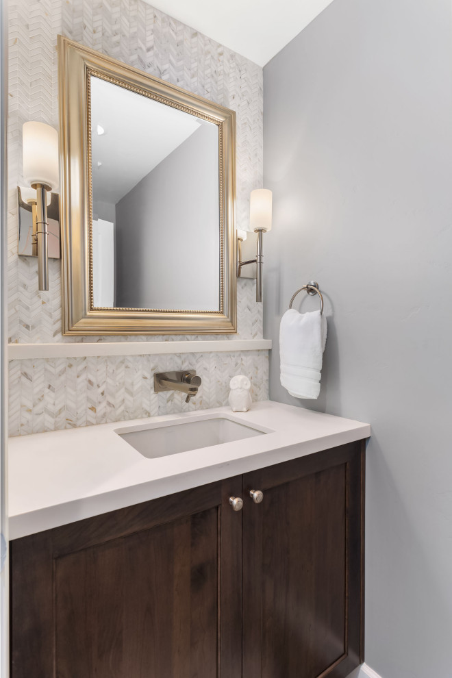 Small transitional white tile and mosaic tile powder room photo in San Francisco with shaker cabinets, brown cabinets, an undermount sink, quartz countertops and white countertops