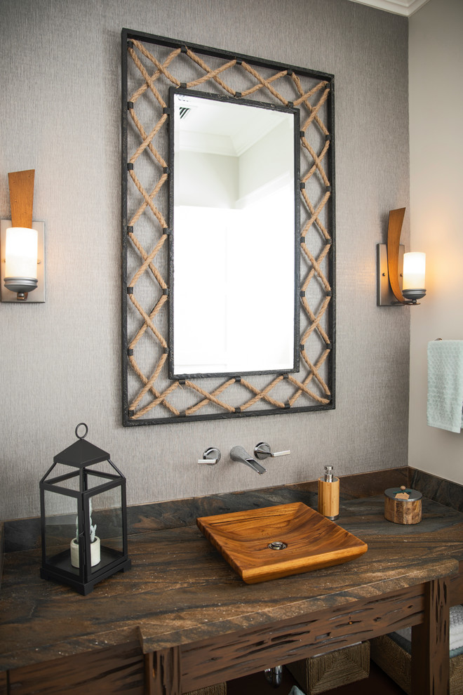 Photo of a coastal cloakroom in Miami with dark wood cabinets, grey walls, a vessel sink and brown worktops.