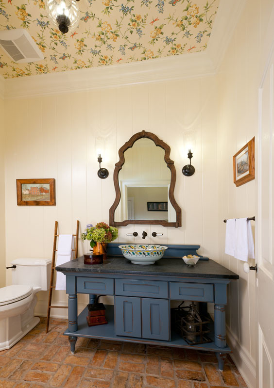This is an example of a medium sized rural cloakroom in Other with a vessel sink, freestanding cabinets, blue cabinets, soapstone worktops and a two-piece toilet.
