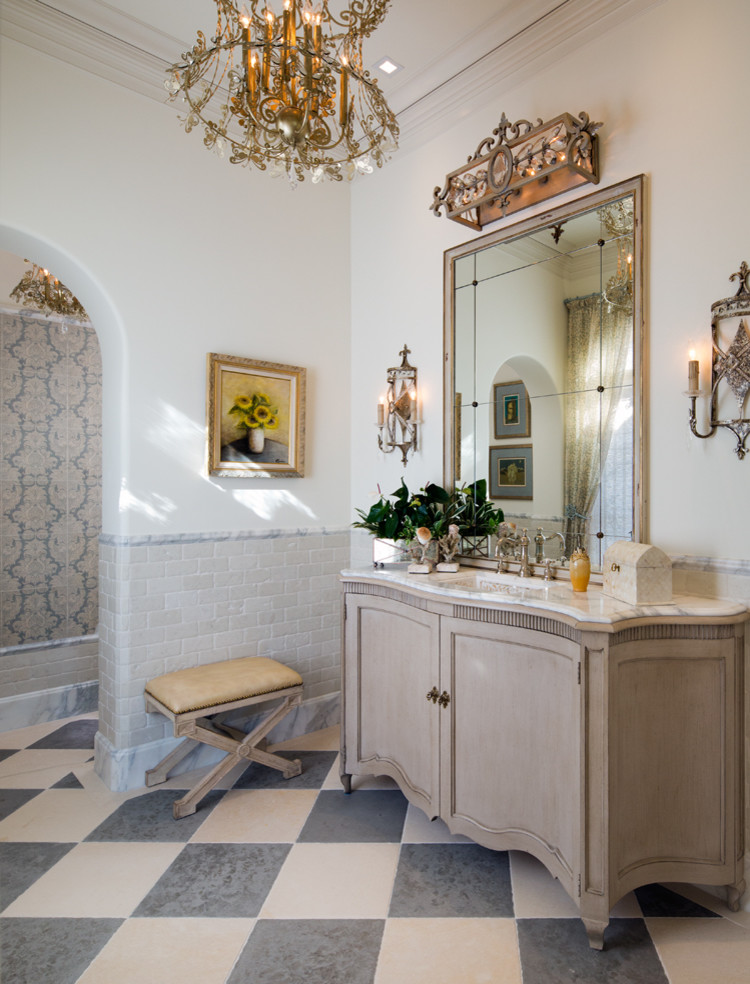 Design ideas for a medium sized mediterranean cloakroom in San Diego with freestanding cabinets, beige cabinets, a submerged sink, marble worktops and white walls.