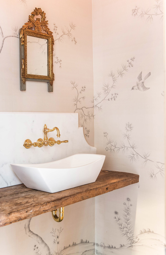 This is an example of a victorian cloakroom in Los Angeles with a vessel sink, wooden worktops, beige walls and brown worktops.