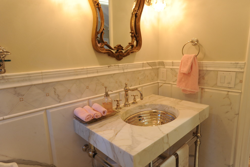This is an example of a small traditional cloakroom in San Francisco with grey tiles, stone tiles, white walls, a pedestal sink and marble worktops.