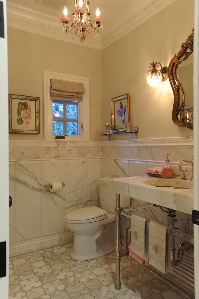 Example of a small classic gray tile and stone tile marble floor powder room design in San Francisco with furniture-like cabinets, a two-piece toilet, white walls, a pedestal sink, marble countertops and white countertops