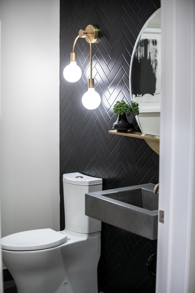 Medium sized retro cloakroom in Los Angeles with open cabinets, a two-piece toilet, black tiles, ceramic tiles, porcelain flooring, an integrated sink, concrete worktops, black floors, grey worktops, dark wood cabinets and black walls.