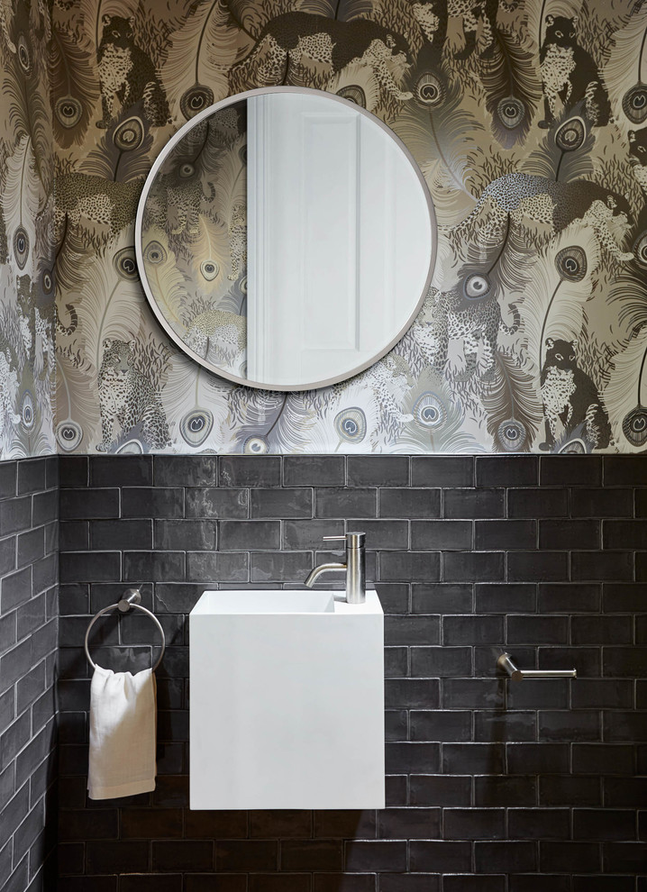 Photo of a contemporary cloakroom in Melbourne with grey tiles, metro tiles, multi-coloured walls and a wall-mounted sink.