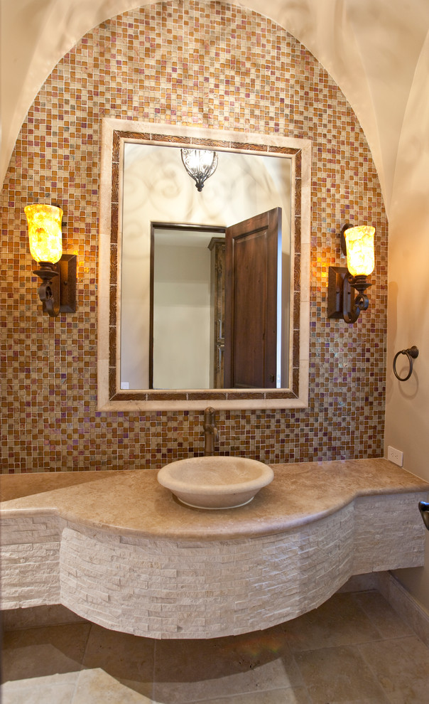 Example of a huge tuscan brown tile and mosaic tile travertine floor powder room design in Houston with a vessel sink, marble countertops and beige walls