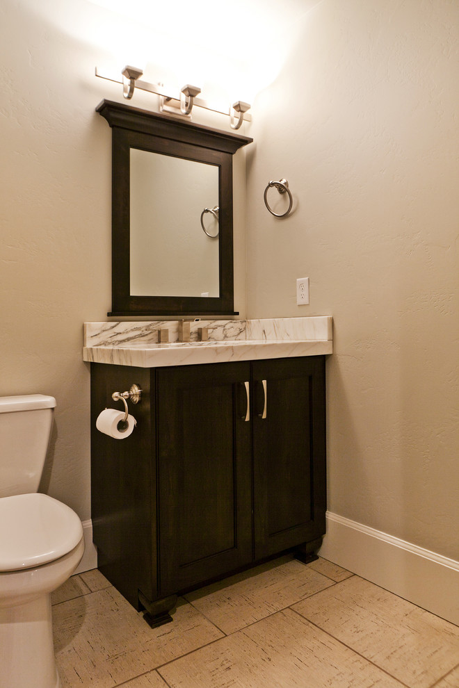 Design ideas for a large classic cloakroom in Salt Lake City with shaker cabinets, dark wood cabinets, a two-piece toilet, grey walls, limestone flooring, a submerged sink and marble worktops.
