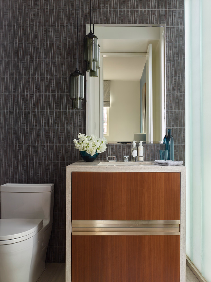 Moderne Gästetoilette mit flächenbündigen Schrankfronten, Toilette mit Aufsatzspülkasten, Unterbauwaschbecken, grauer Wandfarbe und dunklen Holzschränken in Los Angeles