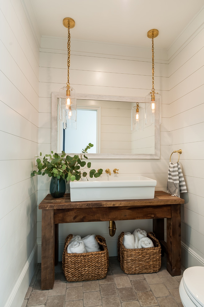 Inspiration for a small cottage white tile limestone floor powder room remodel in Los Angeles with open cabinets, medium tone wood cabinets, white walls, a vessel sink, wood countertops and brown countertops