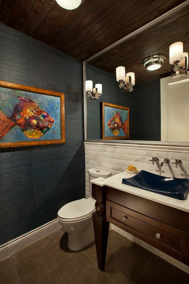 Photo of a medium sized traditional cloakroom in Miami with freestanding cabinets, dark wood cabinets, a one-piece toilet, metro tiles, grey walls, a vessel sink and marble worktops.