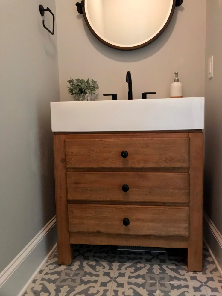 This is an example of an expansive modern cloakroom in Other with shaker cabinets, brown floors, a two-piece toilet, grey walls, a submerged sink, white worktops, a freestanding vanity unit, brown cabinets and porcelain flooring.