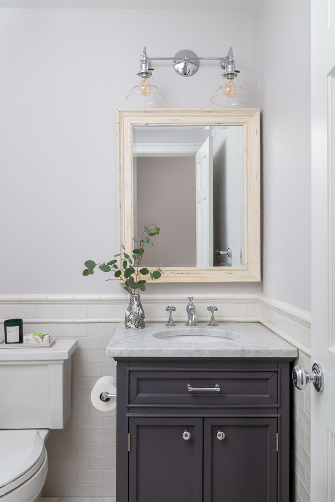 Inspiration for a classic cloakroom in Boston with recessed-panel cabinets, grey cabinets, white tiles, metro tiles, grey walls, a submerged sink and white worktops.