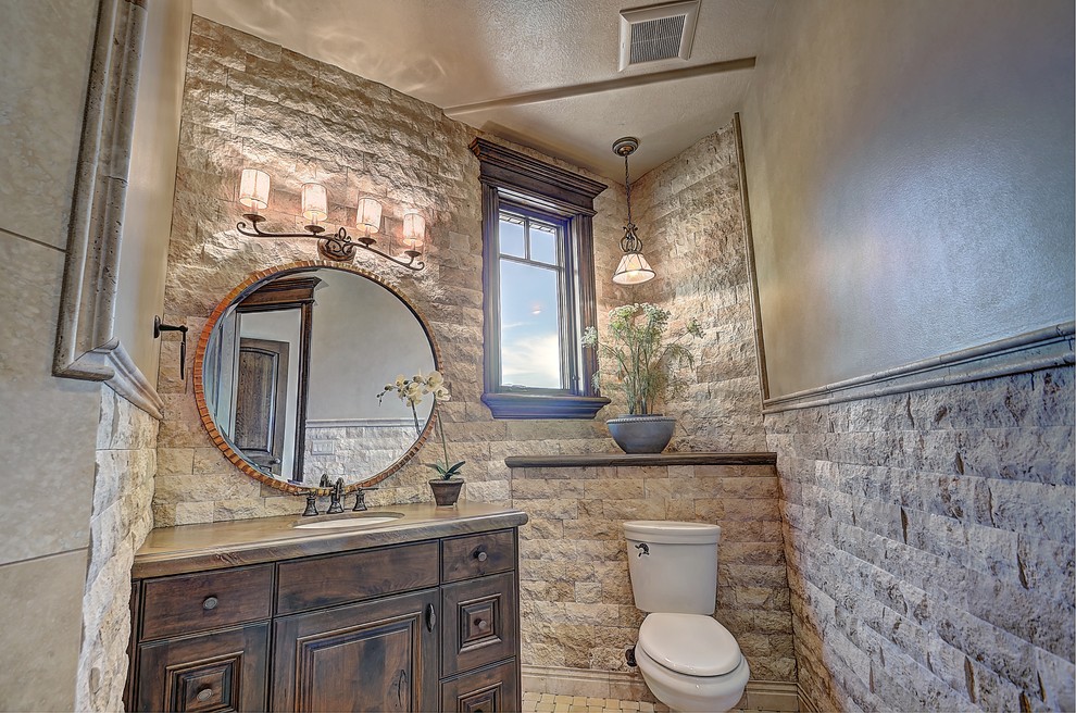 Photo of a large rustic cloakroom in Salt Lake City with a built-in sink, dark wood cabinets, concrete worktops, a one-piece toilet, white tiles, stone tiles and raised-panel cabinets.