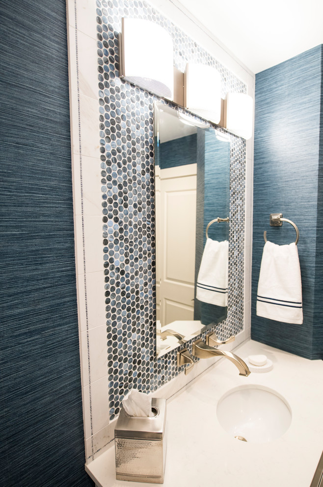Design ideas for a small classic cloakroom in Boston with flat-panel cabinets, white cabinets, a one-piece toilet, blue tiles, glass sheet walls, blue walls, ceramic flooring, a submerged sink and beige floors.