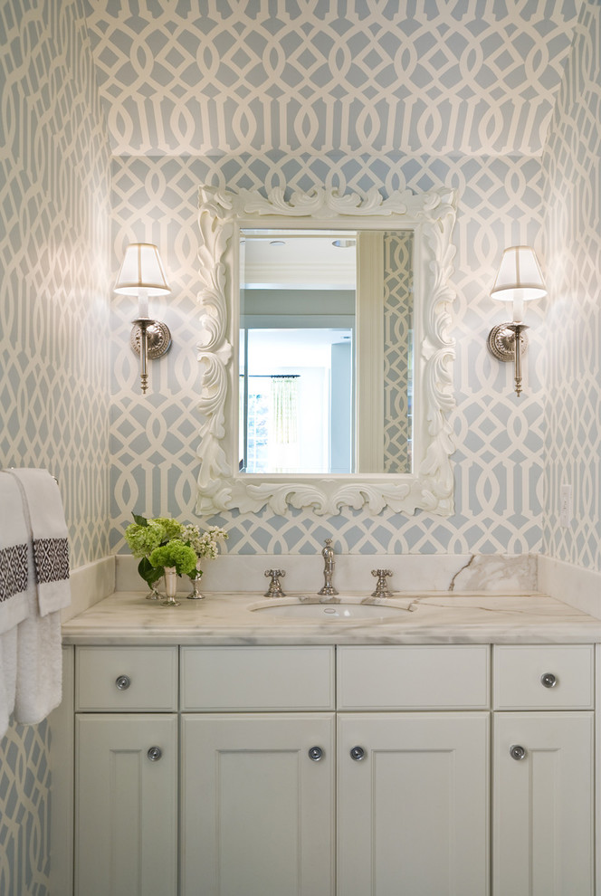 Inspiration for a timeless powder room remodel in Seattle with an undermount sink, recessed-panel cabinets, white cabinets, marble countertops and white countertops