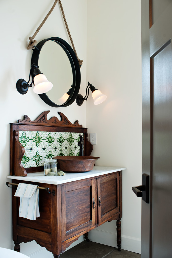Inspiration for a mediterranean cloakroom in Vancouver with a vessel sink, freestanding cabinets, dark wood cabinets and green tiles.