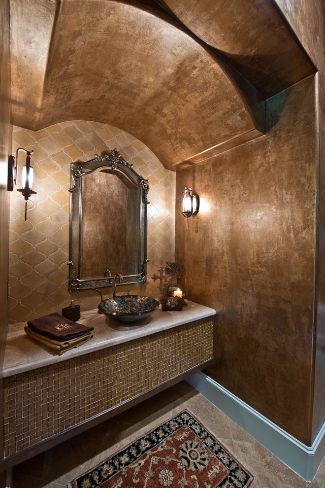 Example of a classic beige tile and mosaic tile travertine floor powder room design in Houston with a vessel sink, limestone countertops and brown walls