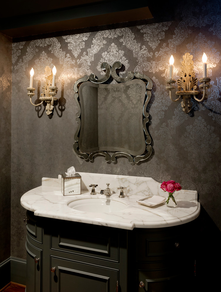 Ornate powder room photo in Houston with furniture-like cabinets, gray cabinets, gray walls, marble countertops, an undermount sink and white countertops