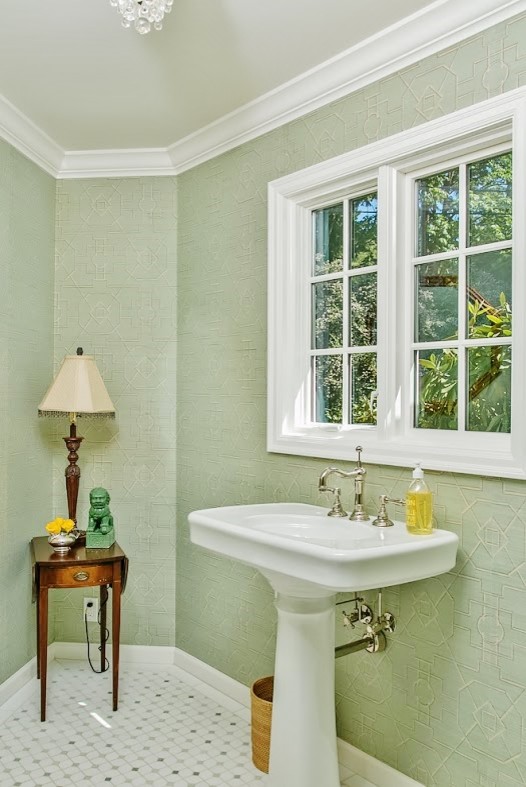 This is an example of a small classic cloakroom in Seattle with green walls, vinyl flooring and a pedestal sink.